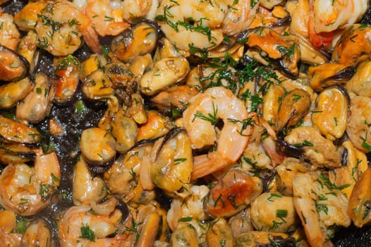 Fried prawns and mussels. grilled seafood close up. cooking process