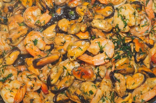 Fried prawns and mussels. grilled seafood close up. cooking process