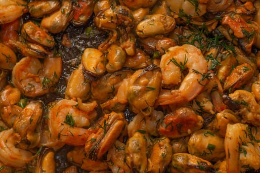 Fried prawns and mussels. grilled seafood close up. cooking process