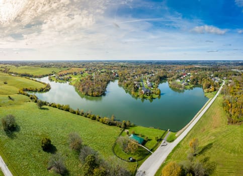 Aerial footage of residential subdivision by a lake in Central Kentucky in fall