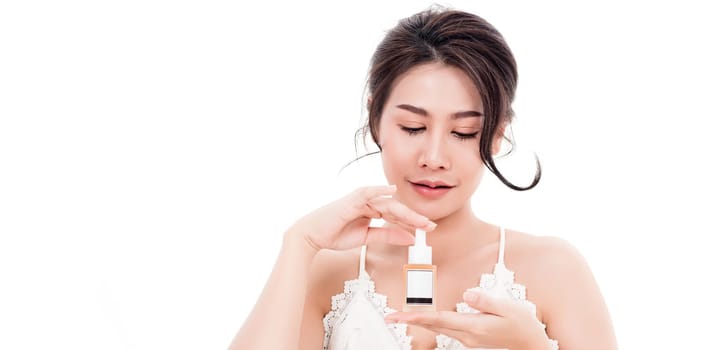 Asian young beautiful woman smiling she's holding bottle serum hair or skin care near face for present product isolated on over white background, Beauty salon concept