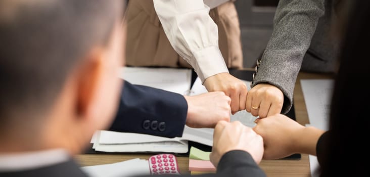 Business people join punching fists bump hands as team their meeting, Giving touch punch together of power teamwork, Business group winning successful company achieving goals with determined staff