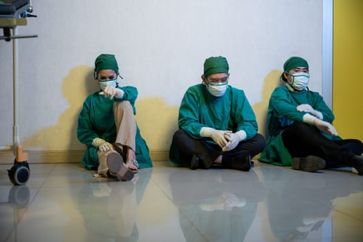 Tired doctor, Group of surgery doctors sadness fatigue after surgery, emotional sitting stress of overworked doctor and medical care team during covid-10, Surgical team tired after operation