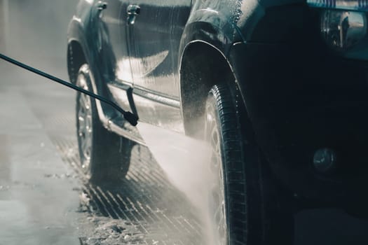 Car wash with pressurized water in car wash outside.