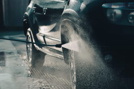 Car wash with pressurized water in car wash outside.