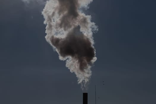 Air pollution from power plant chimneys. Industry and global warming concept
