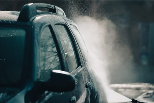 Car wash with pressurized water in car wash outside.