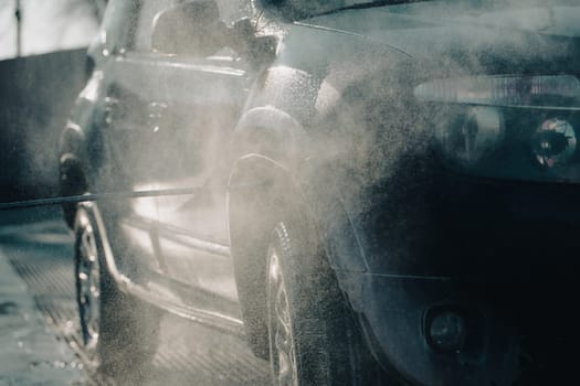 Car wash with pressurized water in car wash outside.