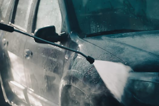 Car wash with pressurized water in car wash outside.