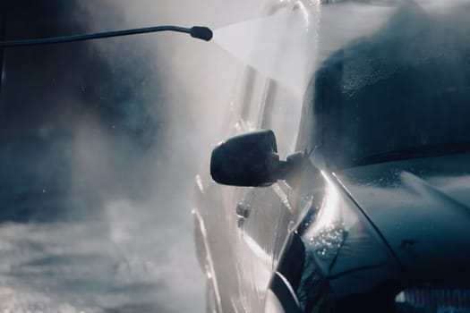 Car wash with pressurized water in car wash outside.