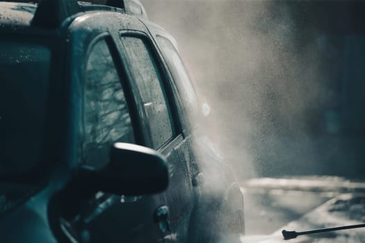Car wash with pressurized water in car wash outside.