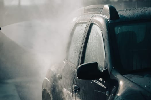 Car wash with pressurized water in car wash outside.