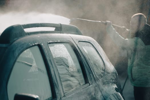 Car wash with pressurized water in car wash outside.