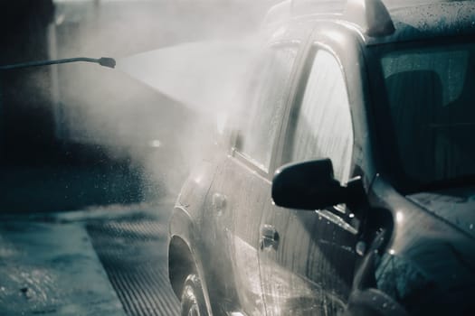 Car wash with pressurized water in car wash outside.