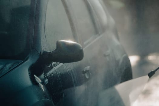 Car wash with pressurized water in car wash outside.