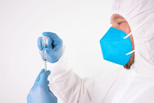 COVID-19 coronavirus vaccine. Vaccination concept. Doctor's hand in blue gloves hold medicine vaccine vial bottle and syringe.
