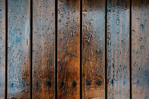 Wooden boards pavement wet from rain, close-up detail from above.
