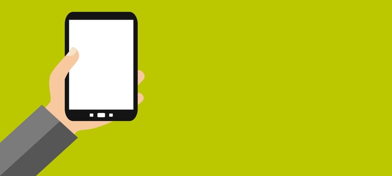 Hand holding smartphone with blank display in front of green background