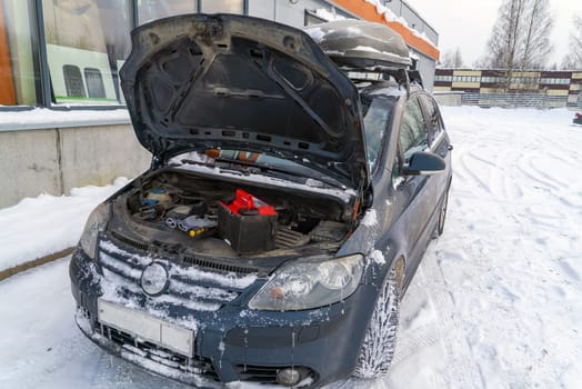 A new battery in the engine compartment of the car in winter