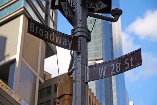 Brown West 28th Street and Broadway historic sign in Midtown Manhattan in New York City