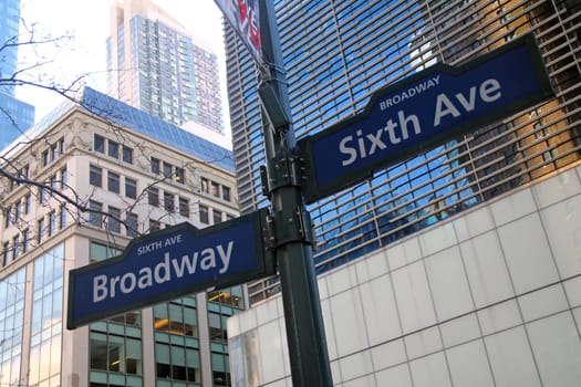 Blue Sixth Avenue and Broadway historic sign in Midtown Manhattan in New York City