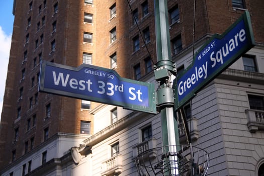Blue West 33rd Street and Greeley Square on Broadway historic sign in Midtown Manhattan in New York City
