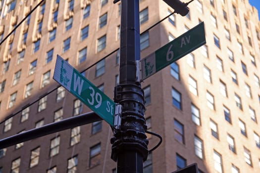 Green West 39th Street and Avenue of the Americas 6th traditional sign in Midtown Manhattan in New York City