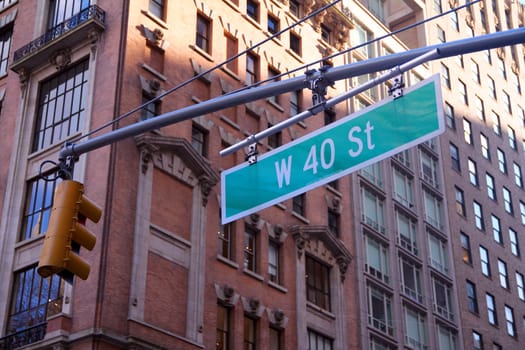 Green big West 40th Street sign hanging on a arch pole in the streets of midtown Manhattan in New York City