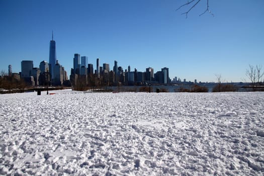 Downtown Manhattan with winter snow on the ground captured from Liberty State Park in Jersey City
