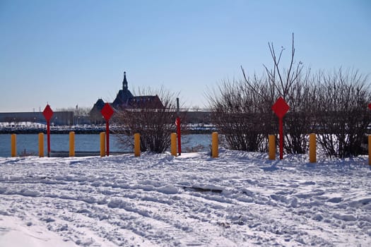 End of the road red signs with snow on the ground and Central Railroad of New Jersey Terminal on the back in Jersey City