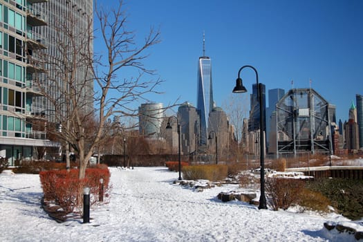 The path in the snow with the skyscrapers of downtown Manhattan on the back in New York City
