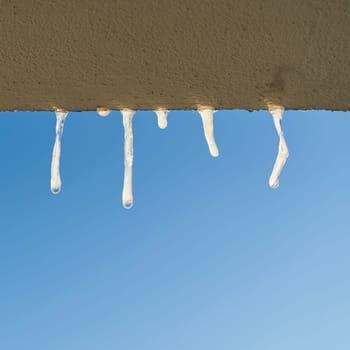 Icicles when looking out of the window of a house in winter