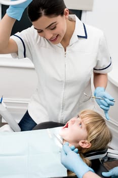 Little girl undergoing dental treatment at clinic