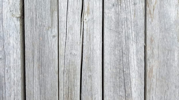 Grunge plank wood texture background. Close up of gray wooden fence panels.