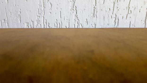Empty top of a natural wooden table and retro white decorative wall. To display the product. Wooden table and white wall. Empty wooden tabletop, counter, shelf in the wall of the room.