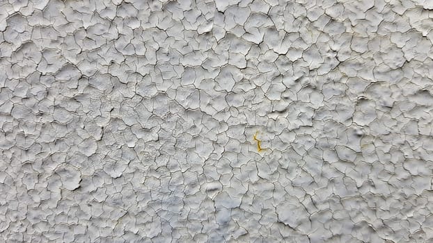 Gray metal wall background. Light peeling texture. Dirty rusty metal wall. Retro effect Cracks, grunge, rough stucco. Old gray metal door. Old gray cracked paint on a metal door
