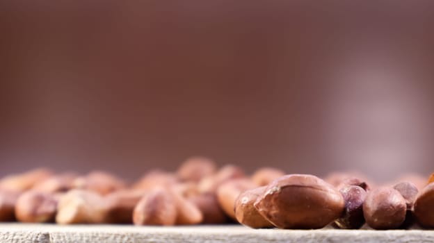 Heap of raw peanuts. Cultivated peanuts, underground or groundnuts. Plant of the legume family. Agricultural crop on an industrial scale. South America is considered the birthplace of peanuts