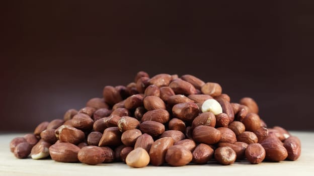 Heap of raw peanuts. Cultivated peanuts, underground or groundnuts. Plant of the legume family. Agricultural crop on an industrial scale. South America is considered the birthplace of peanuts
