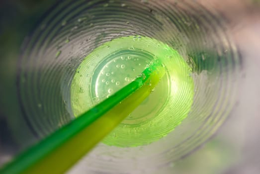 Mojito cocktail in a glass, inside a plastic glass close-up.
