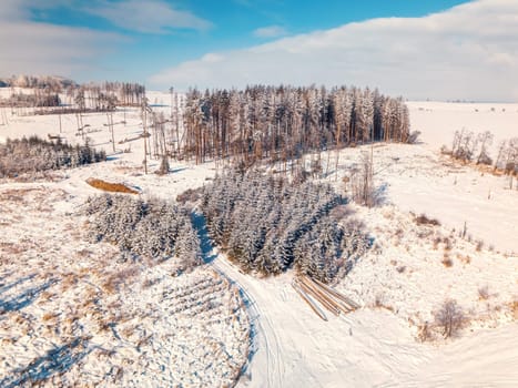 Aerial view of winter landscape covered by snow in sunny day. Czech Republic, Vysocina region highland