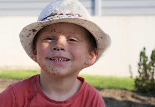 a portrait of young child with a summer hat
