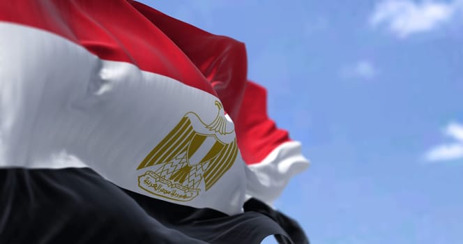 Detail of the national flag of Egypt waving in the wind on a clear day. Democracy and politics. Patriotism. Northeastern african country . Selective focus.