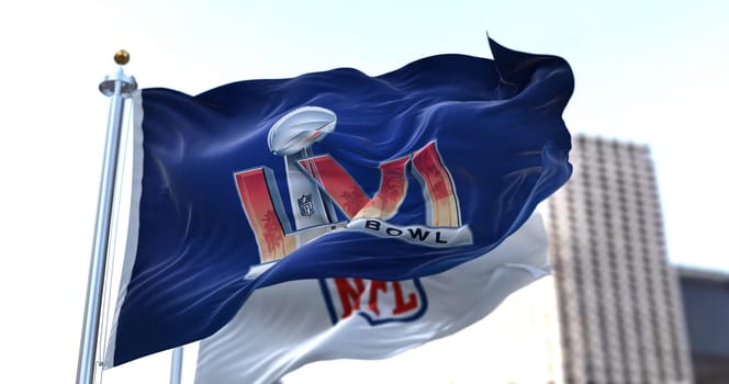 Inglewood, CA, USA, January 2022: The flag with the LVI Super Bowl logo waving in the wind with the NFL flag blurred in the background. The game is scheduled to take place on February 13, 2022