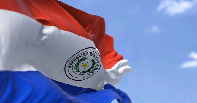 Detail of the national flag of Paraguay waving in the wind on a clear day. Democracy and politics. Patriotism. South american country. Selective focus.