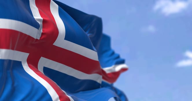 Detail of the national flag of Iceland waving in the wind on a clear day. Democracy and politics. Patriotism. Selective focus. Seamless Slow motion