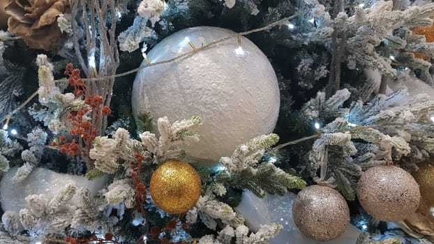 Close-up of a Christmas background. Celebration. Christmas tree with toys and decorative snow for a happy new year. Christmas decorations, New Year's atmosphere. Beautiful modern postcard