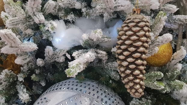 Close-up of a Christmas background. Celebration. Christmas tree with toys and decorative snow for a happy new year. Christmas decorations, New Year's atmosphere. Beautiful modern postcard