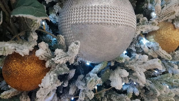 Close-up of a Christmas background. Celebration. Christmas tree with toys and decorative snow for a happy new year. Christmas decorations, New Year's atmosphere. Beautiful modern postcard