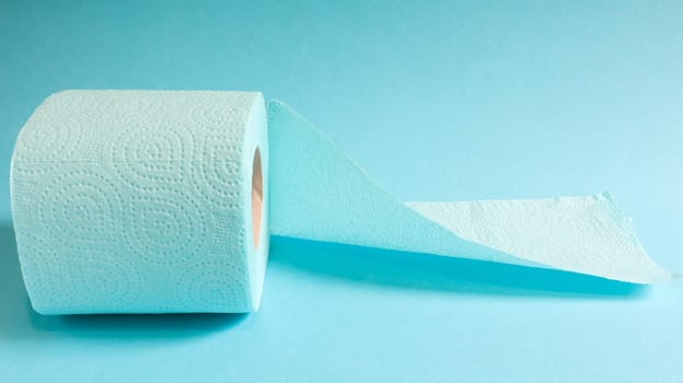 Blue roll of modern toilet paper on a blue background. A paper product on a cardboard sleeve, used for sanitary purposes from cellulose with cutouts for easy tearing. Embossed drawing.