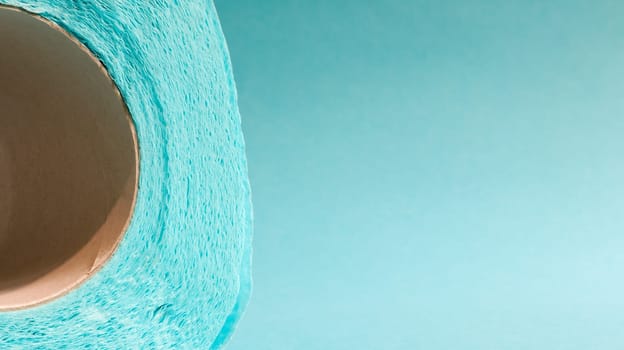 Blue roll of modern toilet paper on a blue background. A paper product on a cardboard sleeve, used for sanitary purposes from cellulose with cutouts for easy tearing. Embossed drawing. copy space